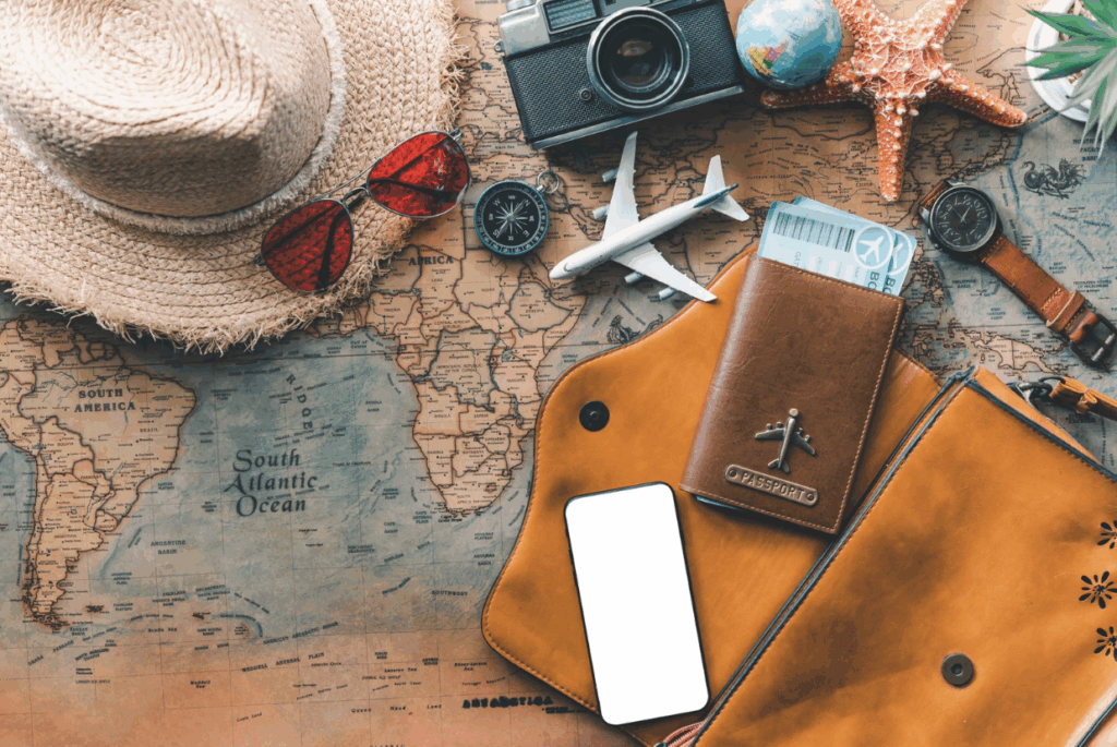 travel items including sunglasses, map and phone